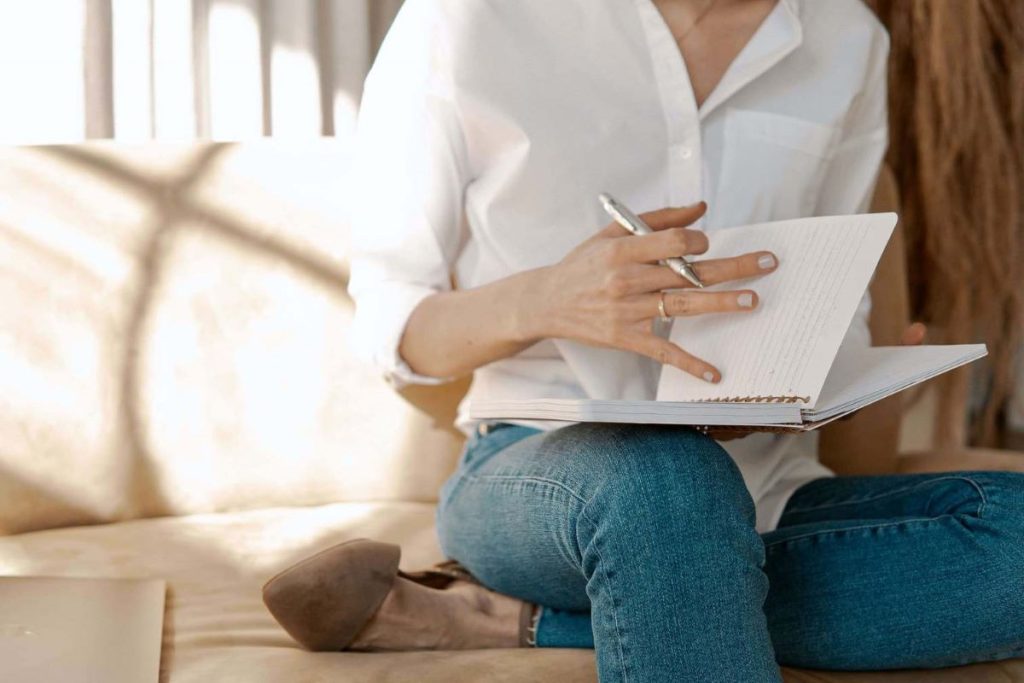 photo of a woman writing in her journal