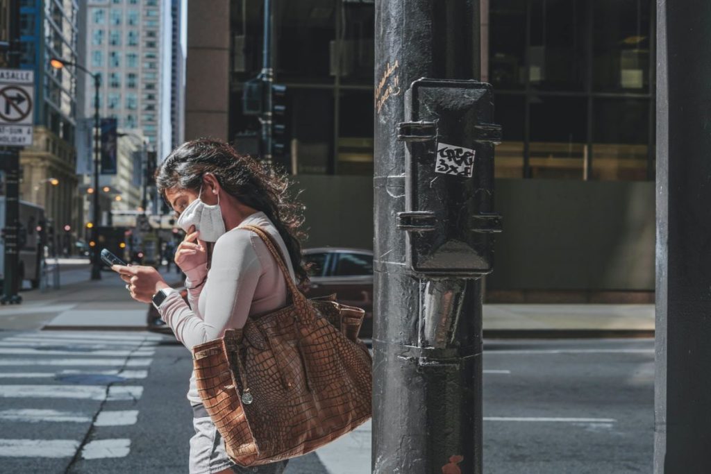 photo of a young woman wearing a face mask while outside