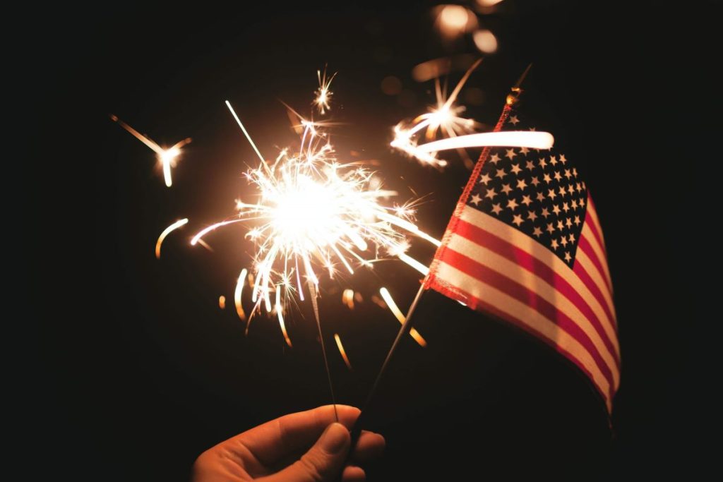 photo of an American flag and a fire stick to celebrate the fourth of july