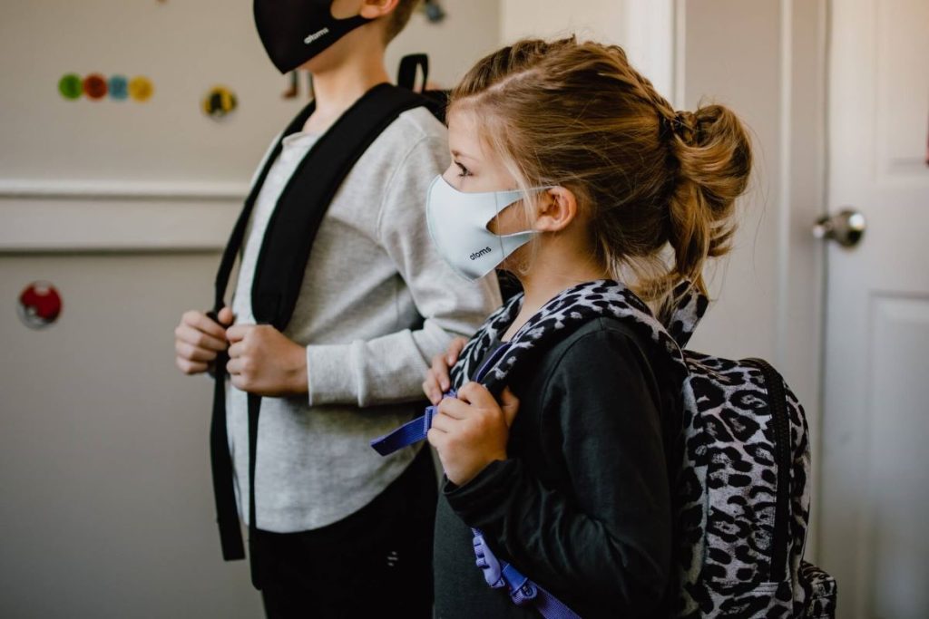 photo of children wearing face masks before heading to school