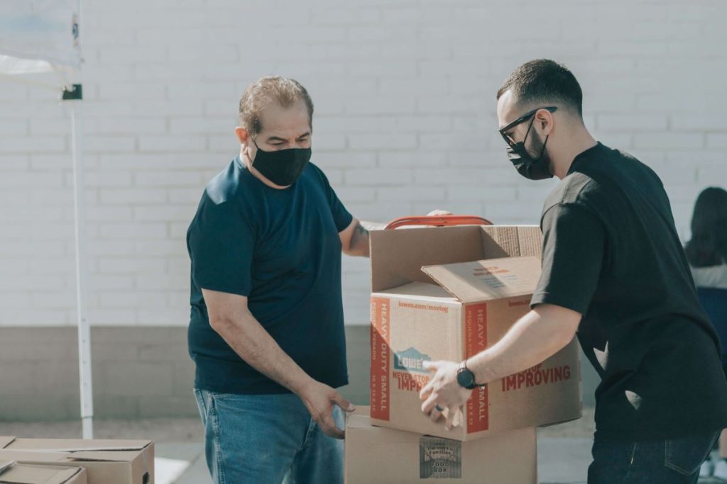 photo of movers carrying boxes