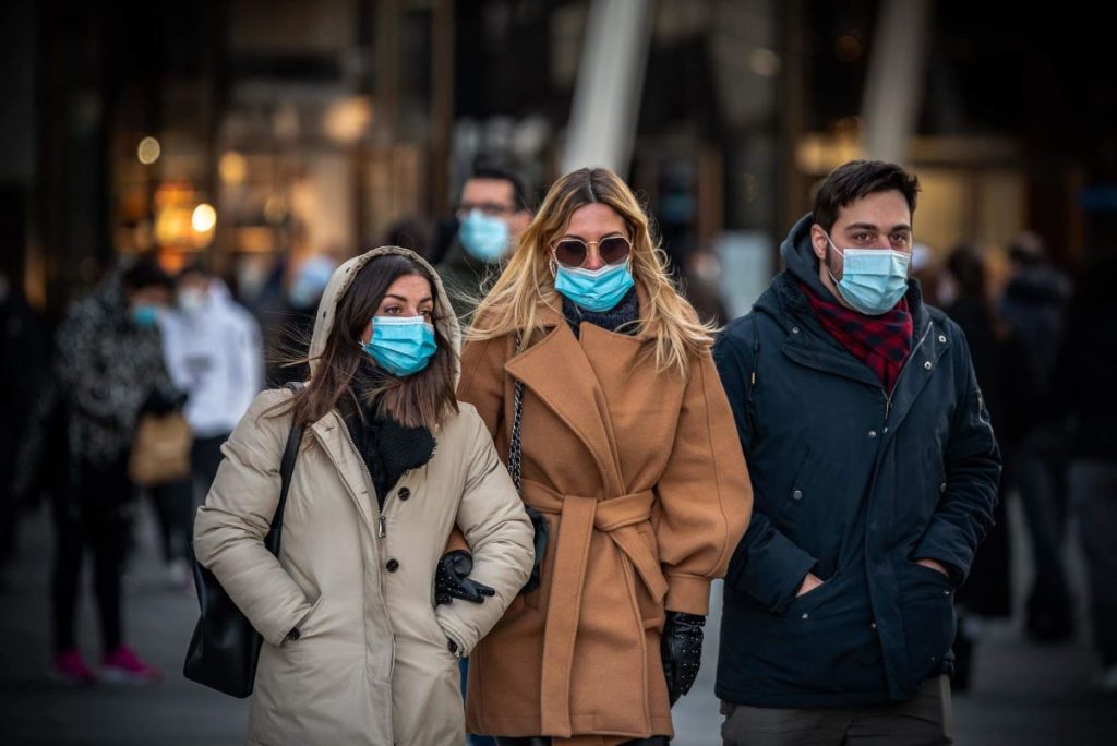 photo of people wearing facemask outside