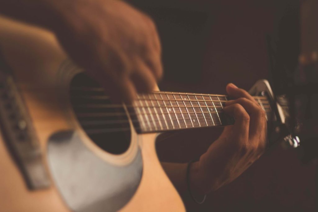 photo of someone playing the guitar
