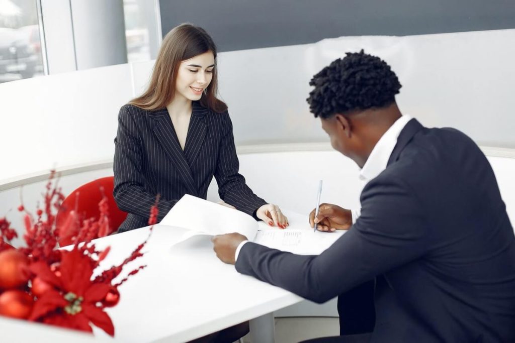 photo of two professionals signing documents