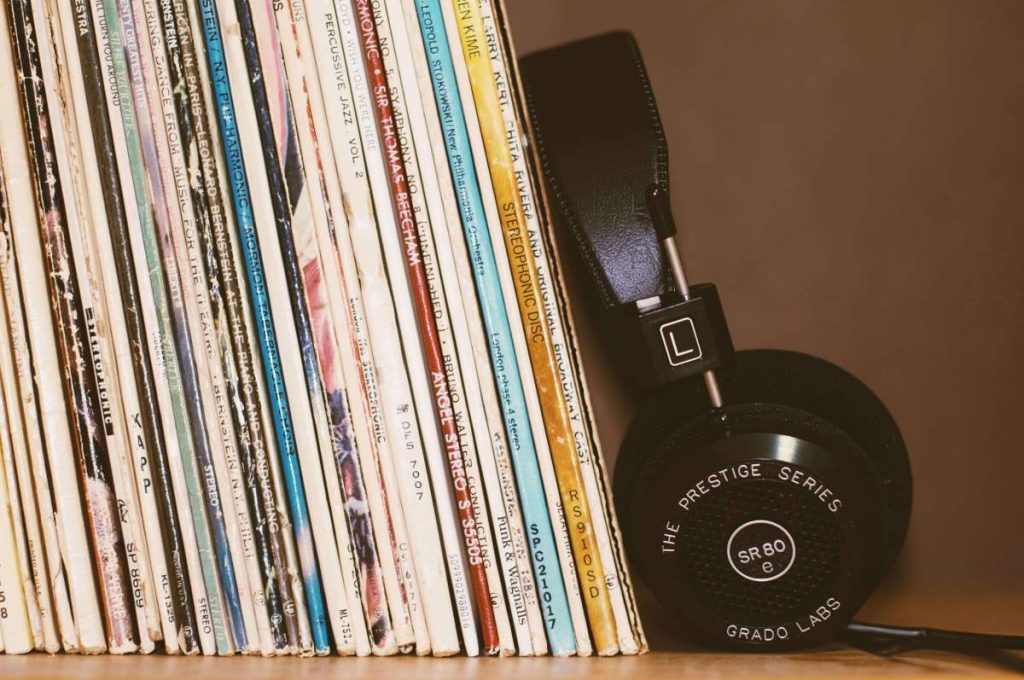 photo of vinyl records in stacks and a headset