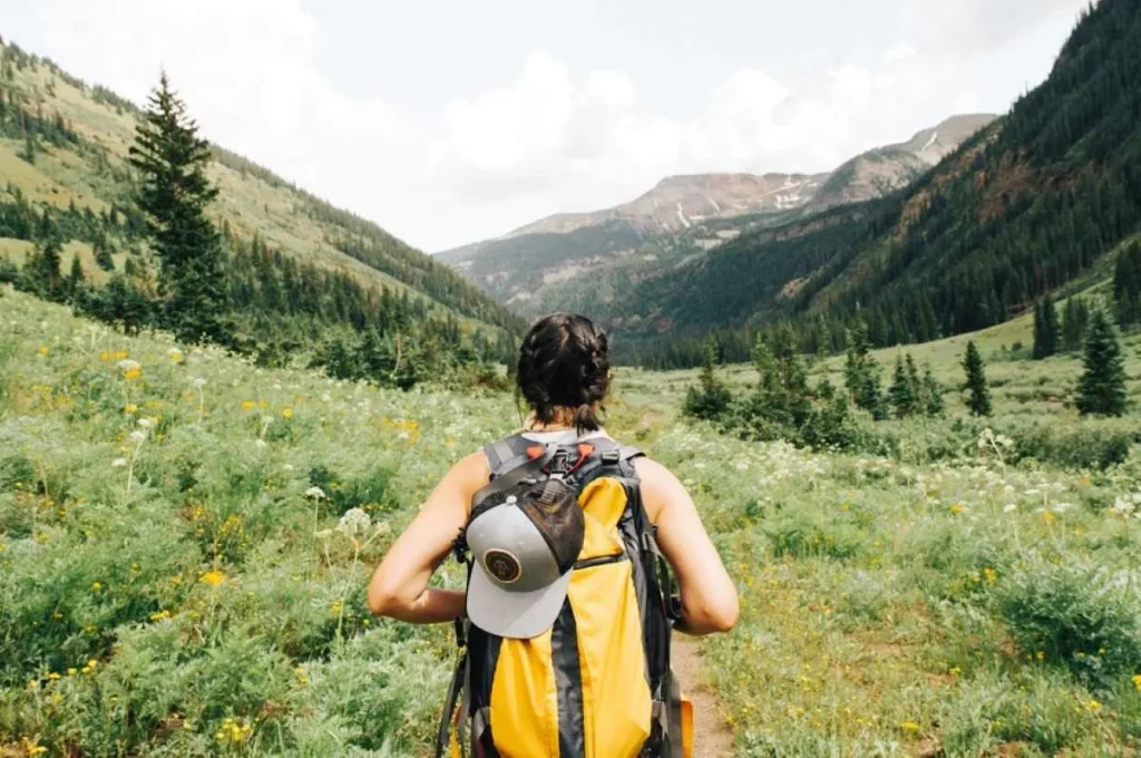 photo of woman hiking in the valley