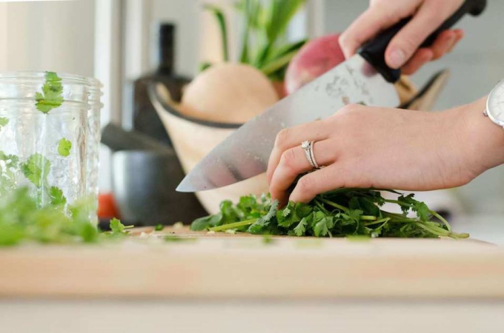 woman dicing vegetables