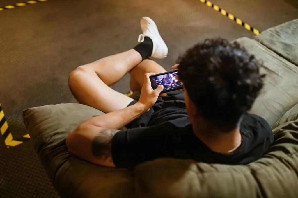 Man-on-a-couch-playing-with-his-phone
