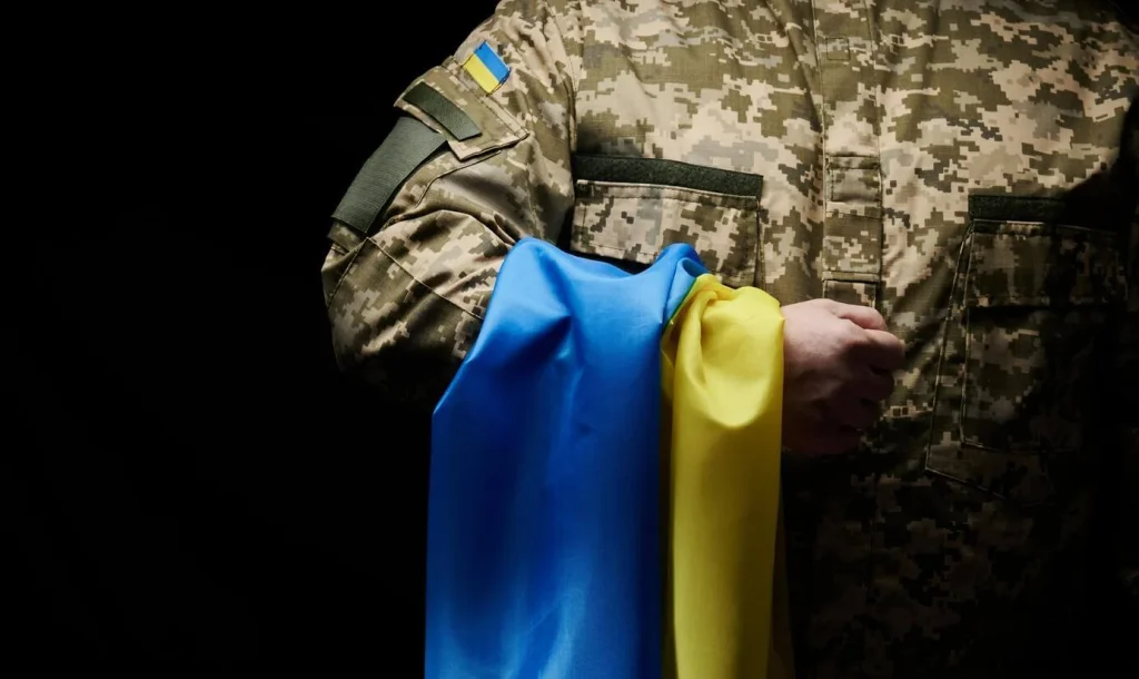 Soldier holding a Ukraine flag Soldier_holding_a_Ukraine_flag