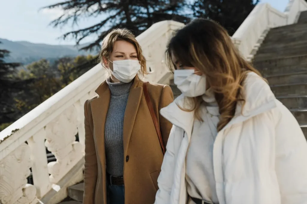 Women outside with face masks What is COVID-19 Alert Level 1