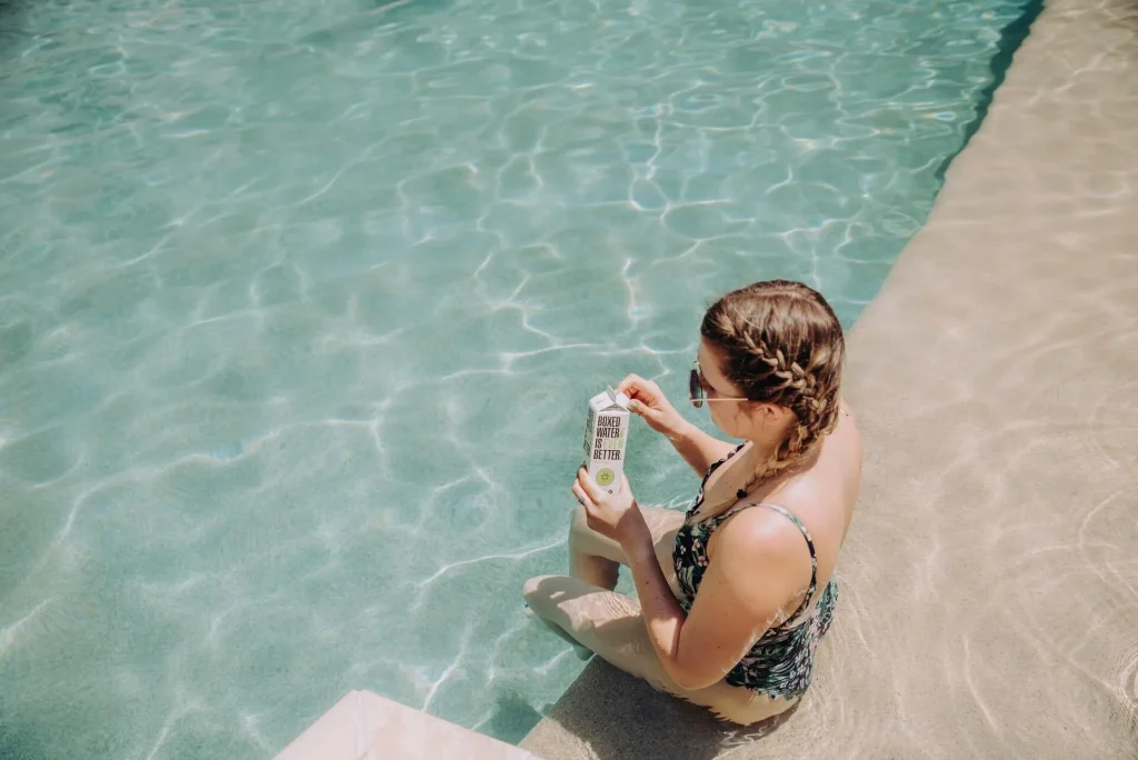 Woman seating by the pool Woman-seating-by-the-pool