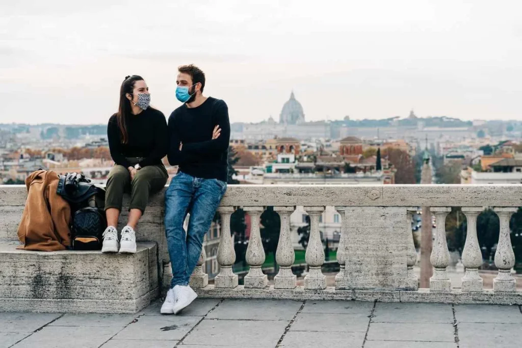 couple traveling wearing a face mask