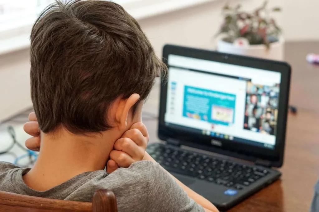 photo of a boy doing online classes