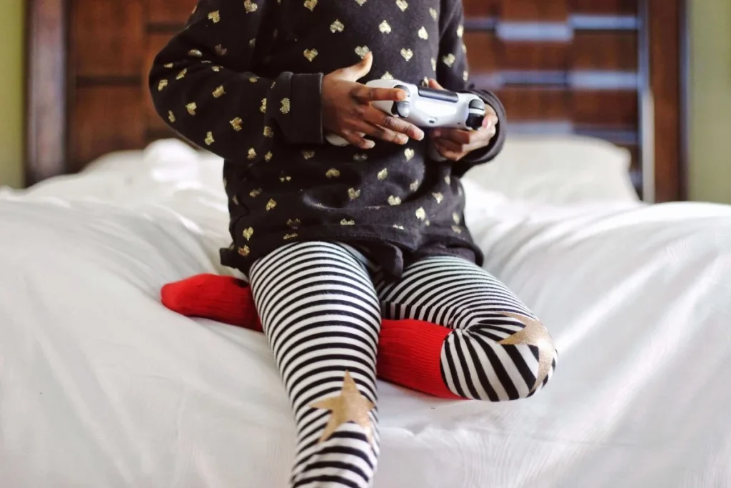 photo of a child holding a game controller