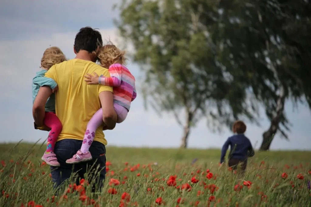 photo of a father and his kids out on a walk