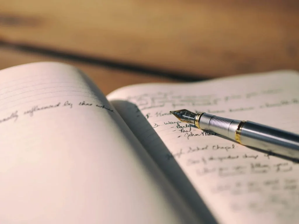 photo of a journal and a fountain pen