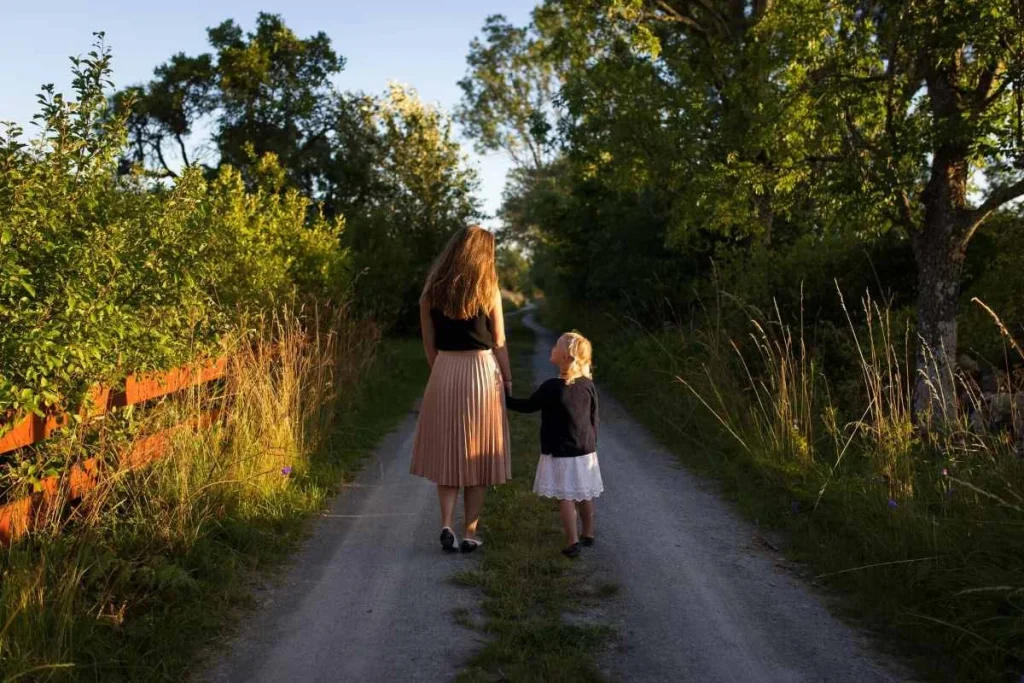 photo of a mother and daughter walking