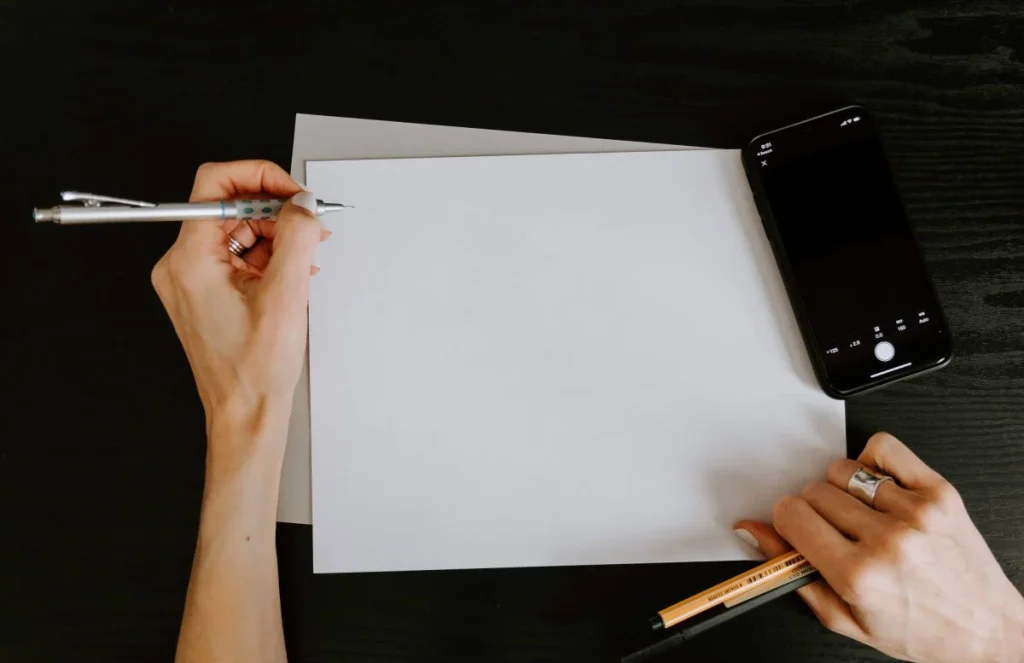 photo of a person about to write on a piece of paper