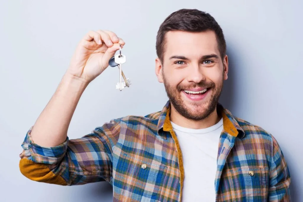 photo of a person holding the keys to his house