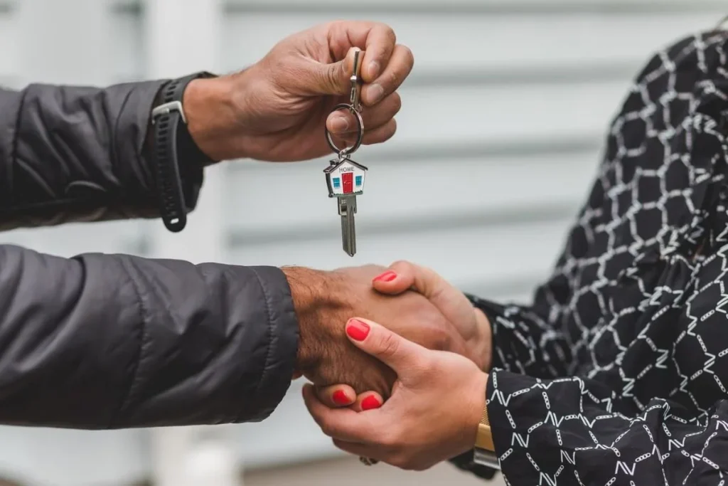 photo of a person passing over house keys