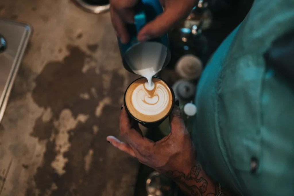 photo of a person pouring coffee