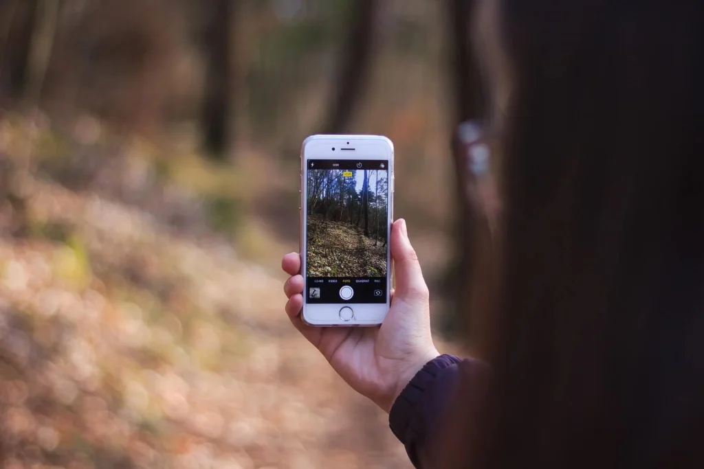 photo of a person using their phone for photography