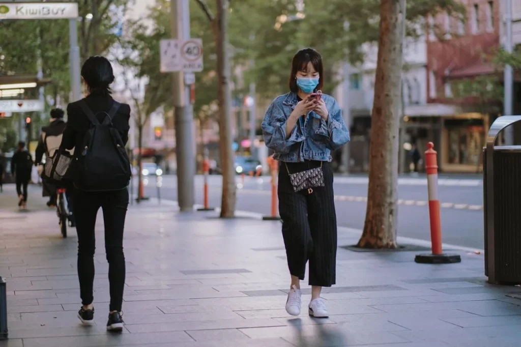 woman walking with face mask woman-walking-with-face-mask