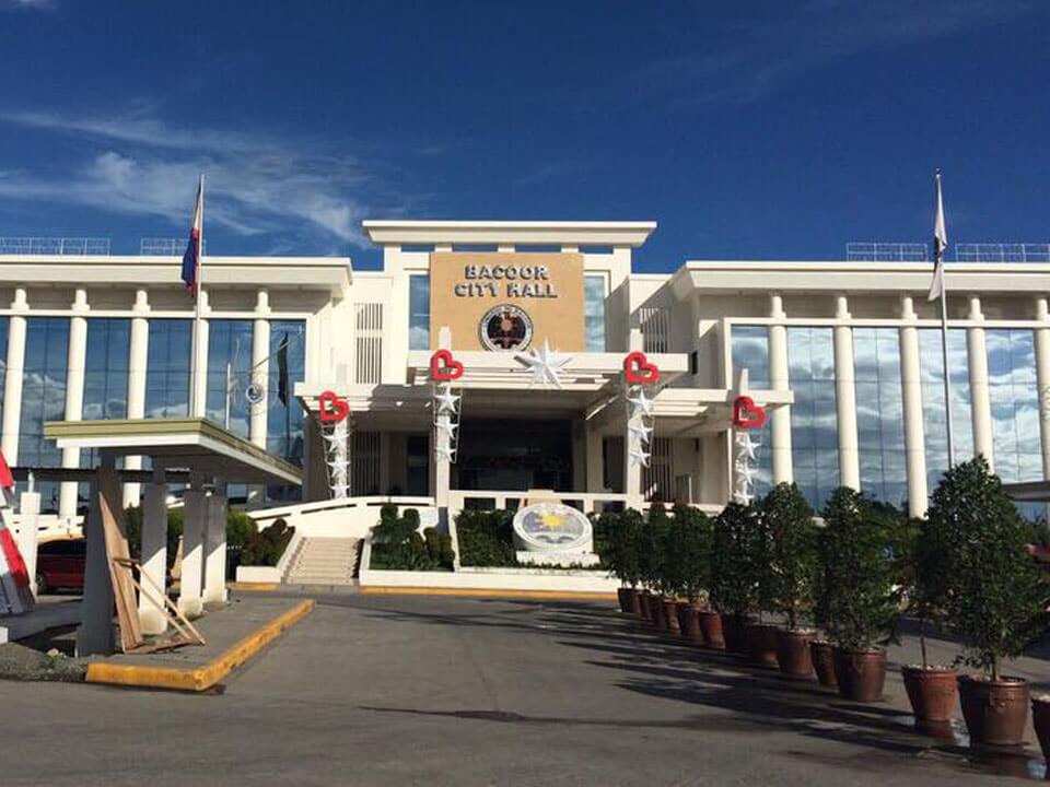 Bacoor City Hall, a prominent landmark in the area of Bacoor, Cavite, with its grand architecture and landscaped entrance, illustrating the significance of the local government in supporting growth and real estate properties opportunities in Bacoor, Cavite.