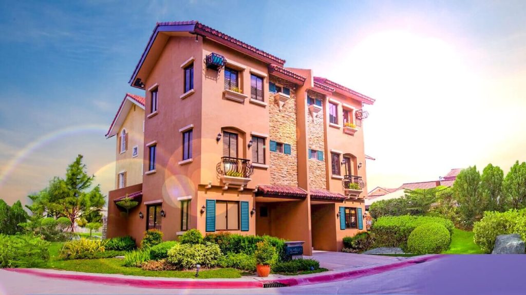 A premium Mediterranean-inspired house model at Carmel by Crown Asia in Bacoor, Cavite, showcasing lush greenery and upscale community living—highlighting real estate properties investment opportunities in the city