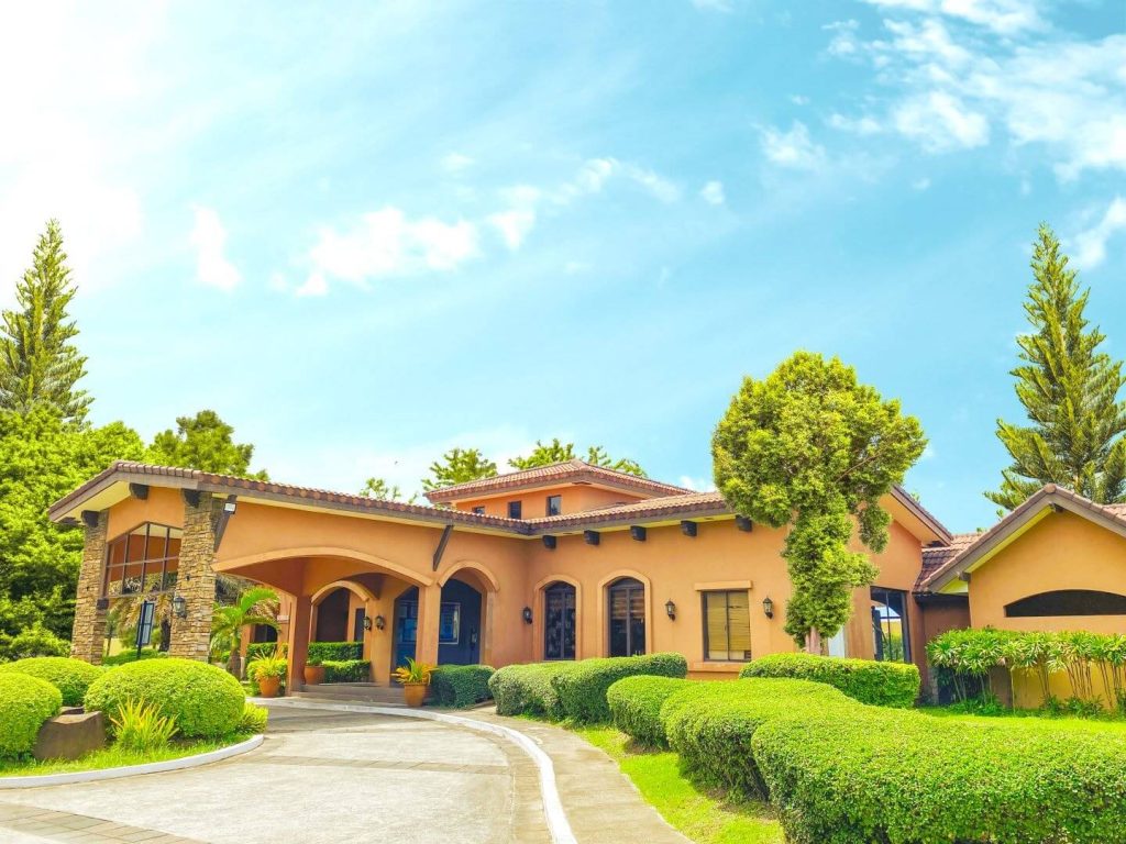 Mediterranean-inspired clubhouse at Vita Toscana by Crown Asia in Bacoor, Cavite, surrounded by landscaped greenery and vibrant architecture, showcasing premium real estate properties investment opportunities in Cavite