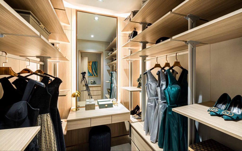 black leather jacket hanged on brown wooden cabinet l right mix of space and storage for your walk in closet 