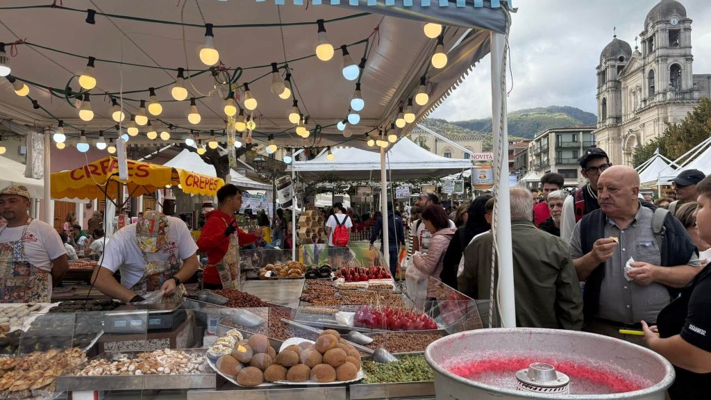 Find typical products at the artisan markets of Sicily during the Ottobrata Zafferanese Festival like cured meats, variety of nuts, fruits, and wines. 